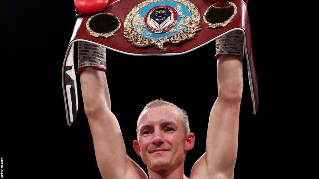 Paul Butler holds his WBO title over his head