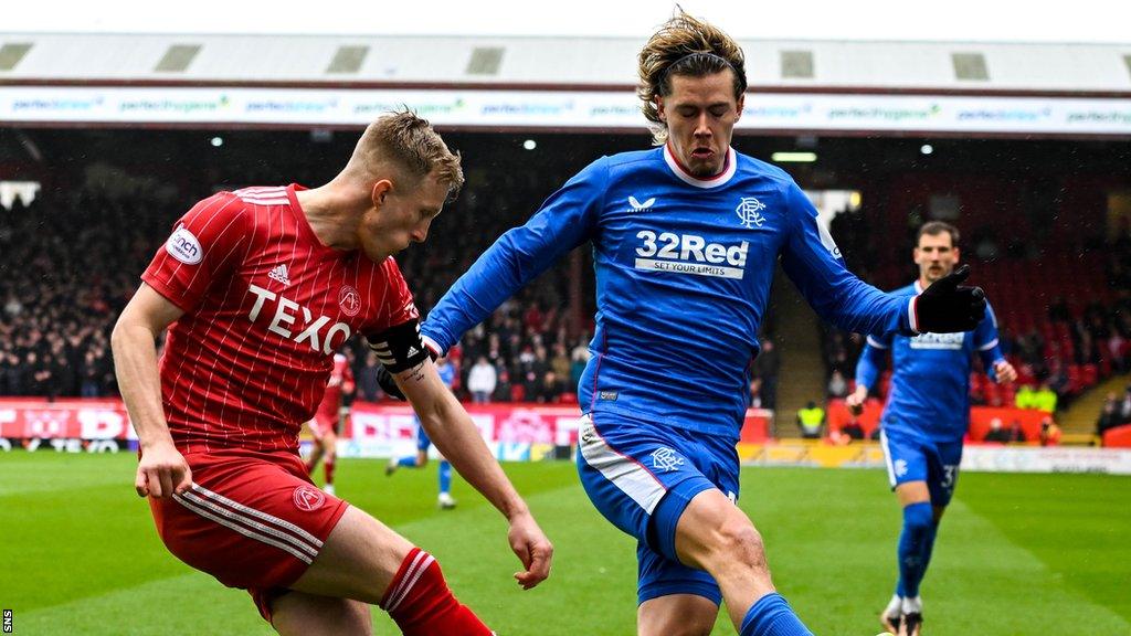 Ross McCrorie tussles with Todd Cantwell in Aberdeen's meeting with Rangers on Sunday