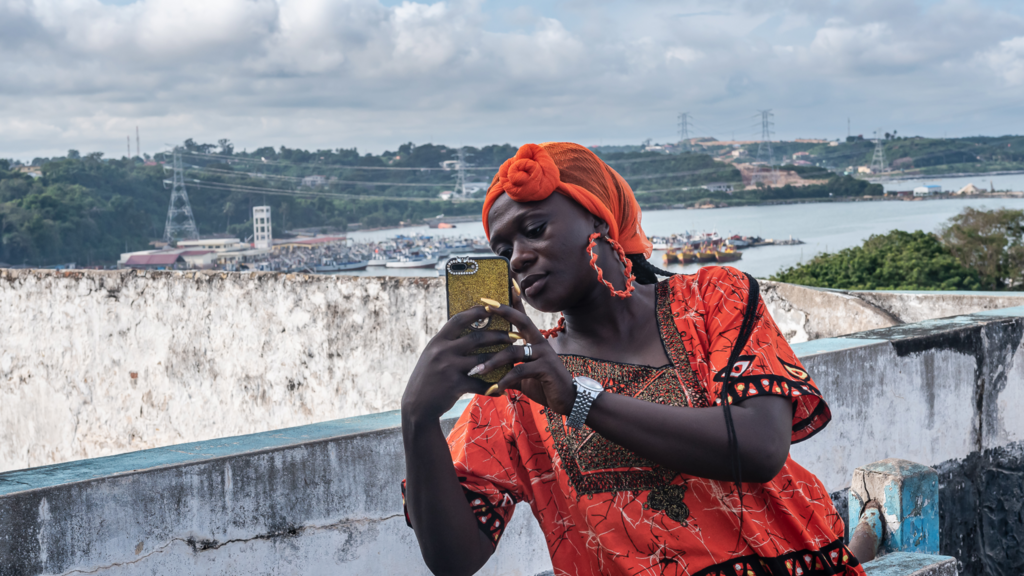 A woman takes a photo in Takoradi, Ghana.