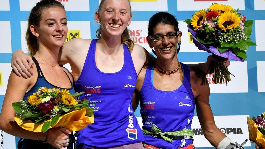 France's Marlene Prat, Britain's Hannah Baldwin and Anita Aggarwal celebrate on the podium after the Para-climbing competition category RP2 at the IFSC Climbing World Championships in Innsbruck, Austria, in September 2018