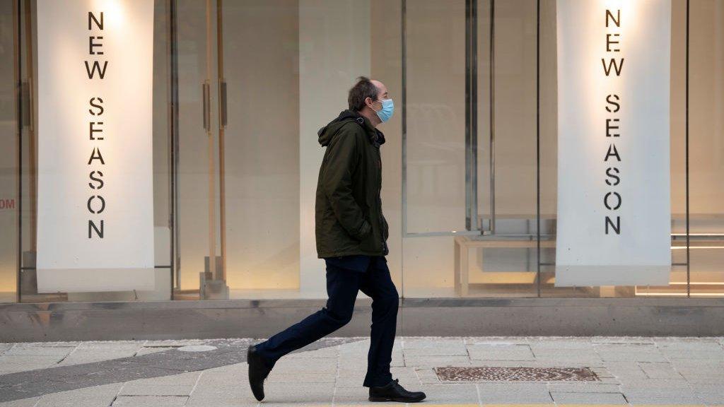 Man in mask walking in Cardiff