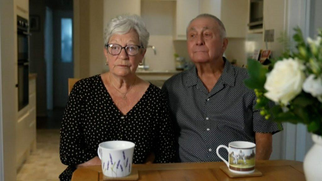 Lianne Sharabi parents, looking at the camera, with cups of tea in front of them