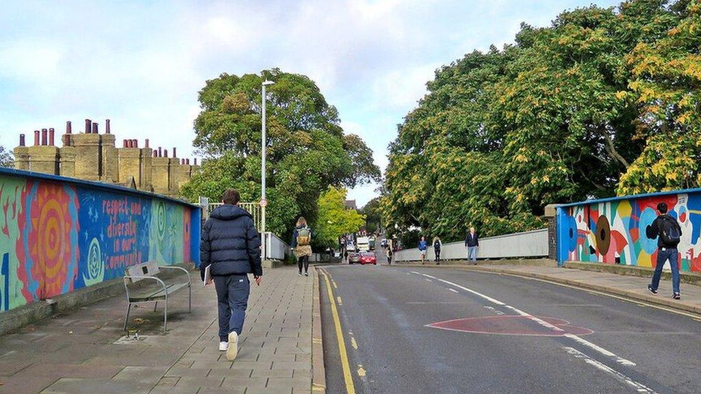 Mill Road in Cambridge with pedestrians walking across