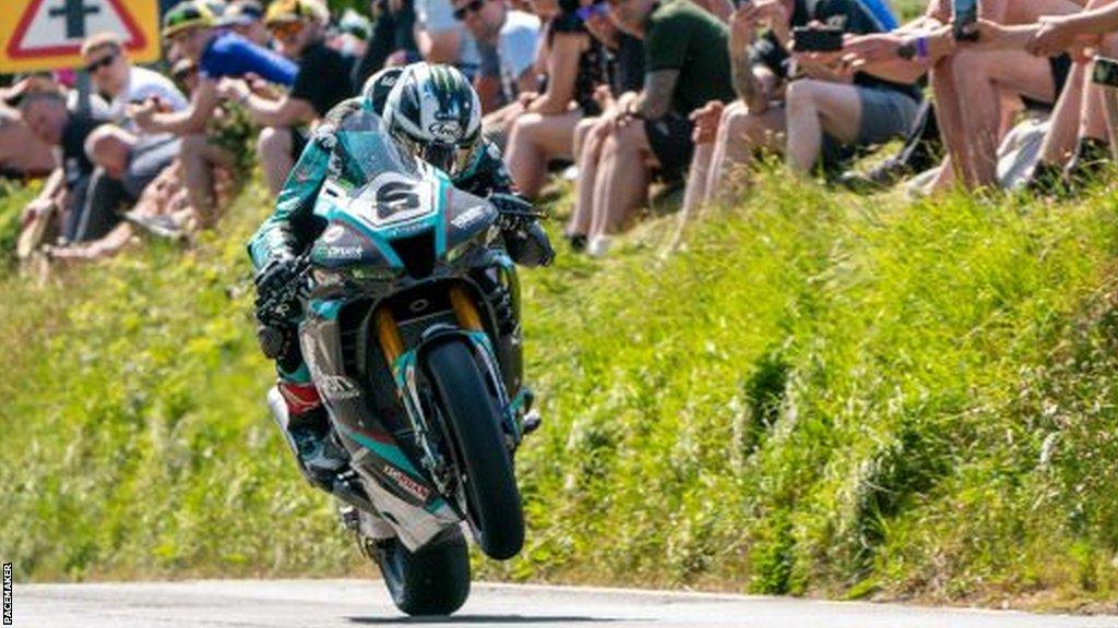 Michael Dunlop gets the front wheel airborne on his way to Superbike race success