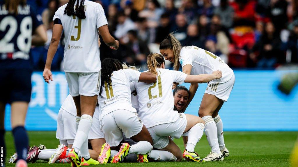 Lyon celebrate scoring against Paris St-Germain