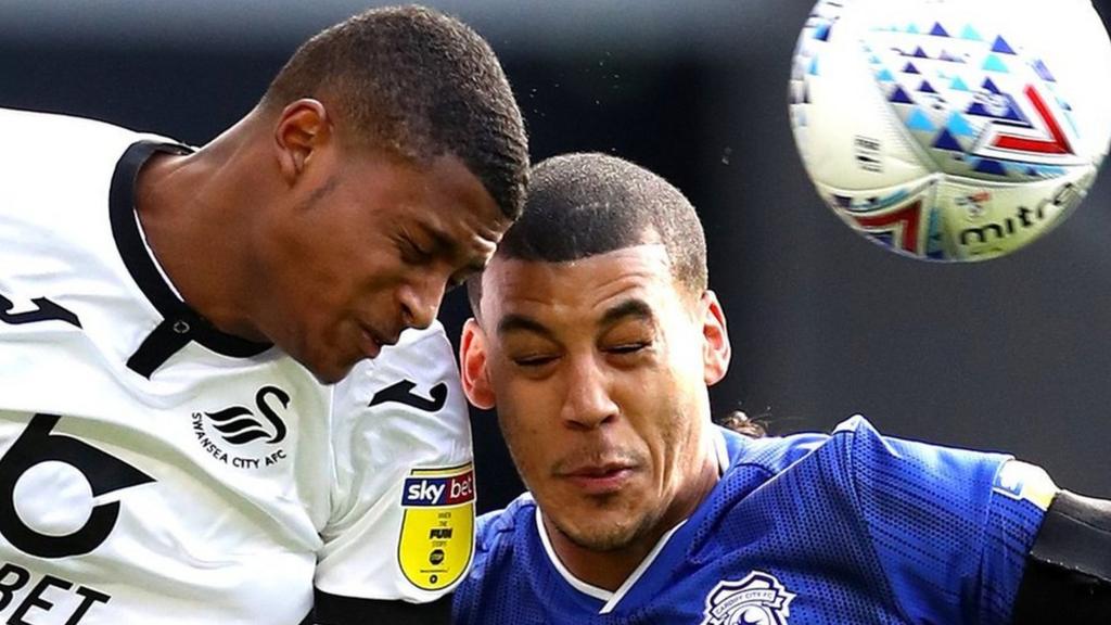 Rhian Brewster and Lee Peltier challenge each other in the air