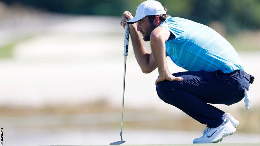 Scottie Scheffler assesses the line of a putt at the Hero World Challenge