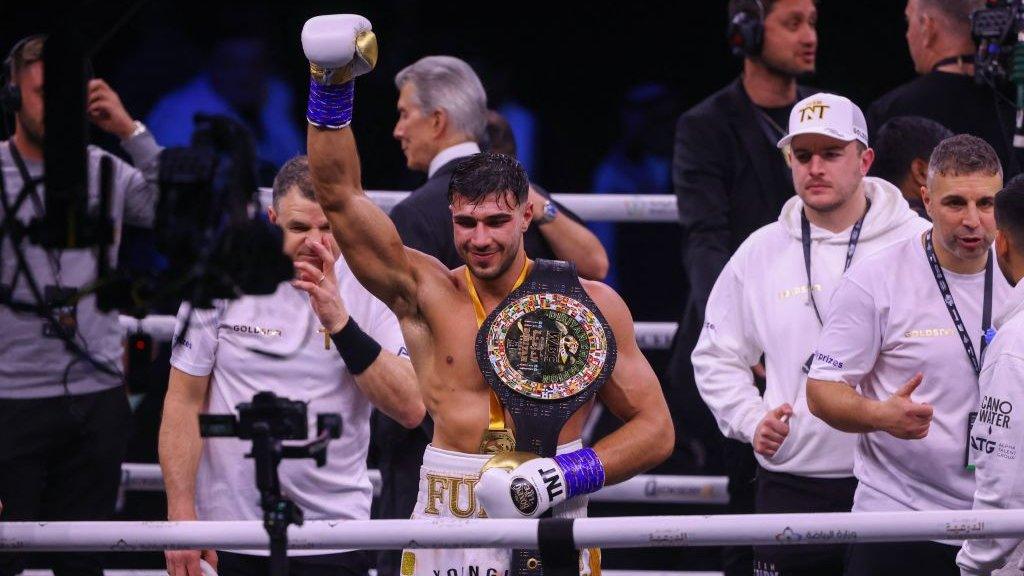 Tommy Fury celebrates in the ring after beating Jake Paul