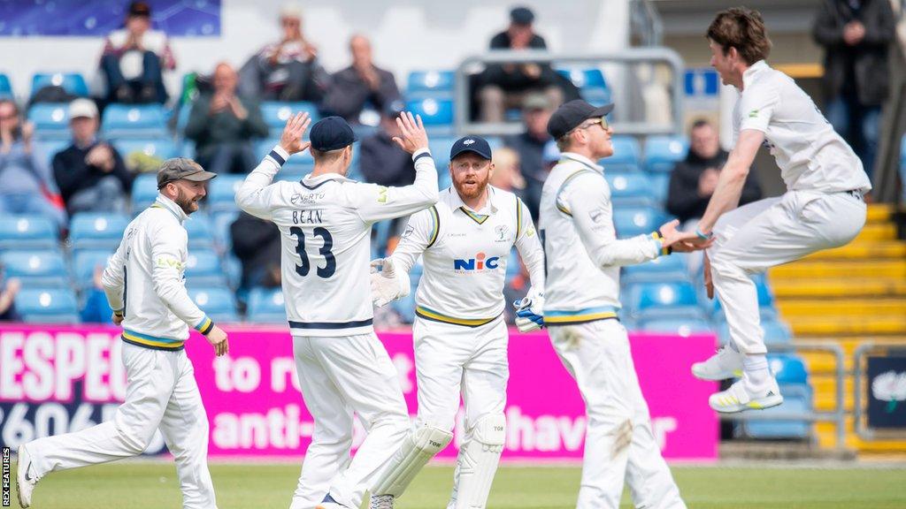 Yorkshire's Jonny Bairstow takes a catch to dismiss Glamorgan's Kiran Carlson as bowler George Hill celebrates