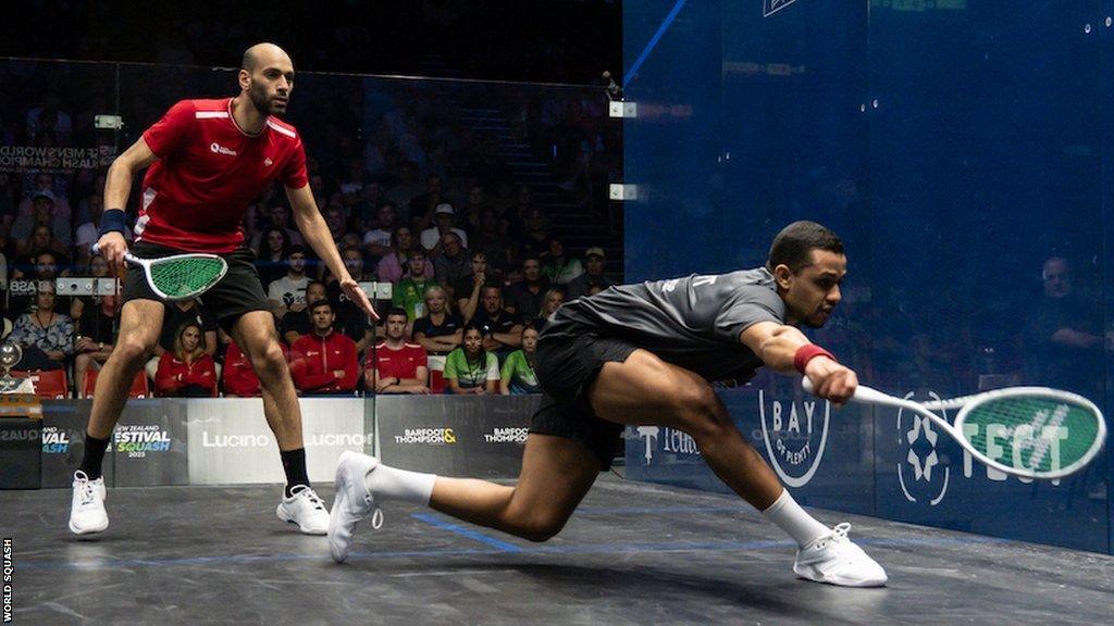 Mostafa Asal plays a shot watched by Marwan ElShorbagy