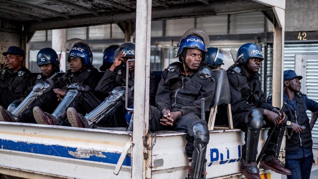 Police wait in a truck