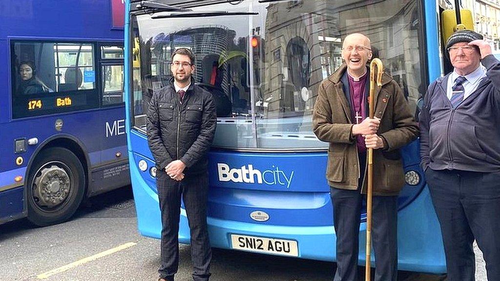 Bishop Michael in front of a bus