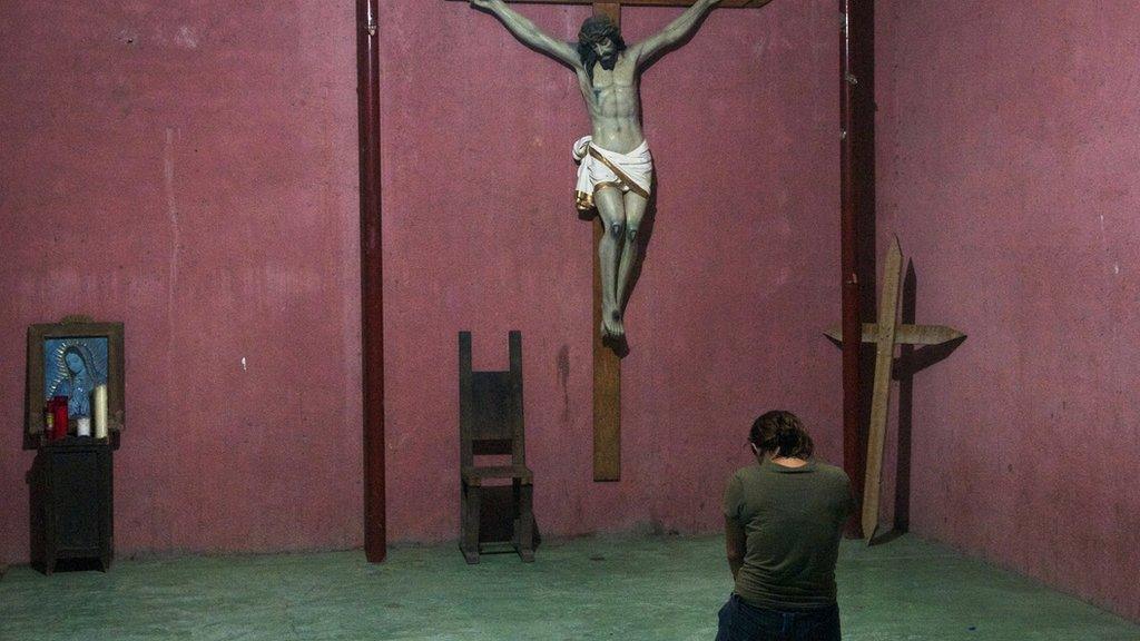 Migrant praying at a refuge