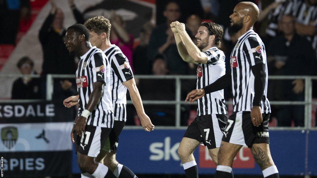 Notts County players celebrate a goal