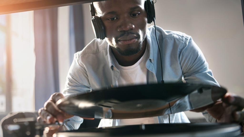 A man placing a record on a record player