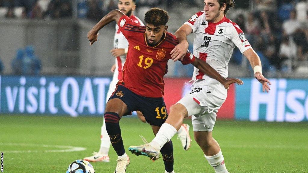 Lamine Yamal challenges for possession in a Euro 2024 qualifier