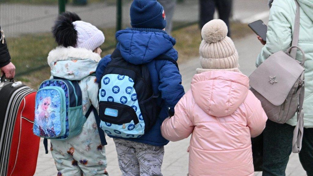 Three children arriving at a border