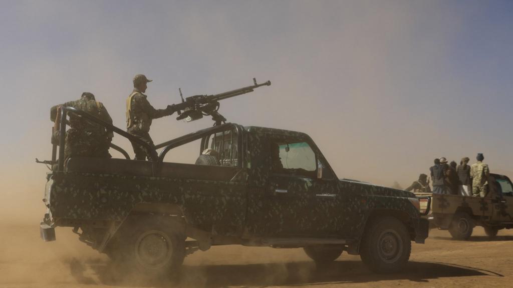 Pick-up trucks carrying Houthi policemen and tribal supporters of the group parade during a protest against US-led strikes on Houthi targets in Yemen