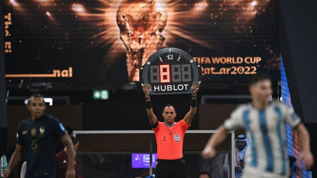 A fourth official shows eight additional minutes at a 2022 World Cup match