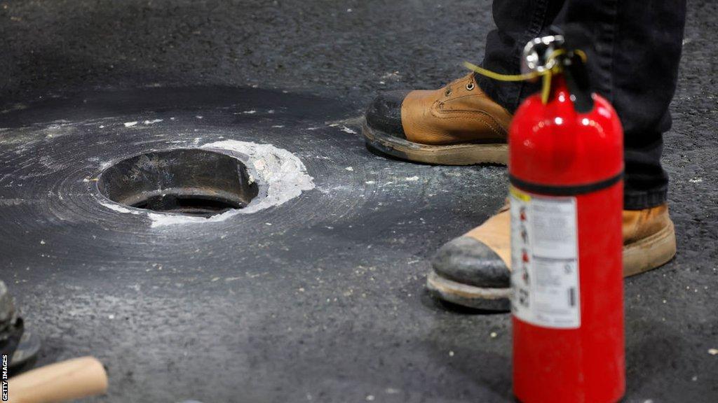 An image of a pothole damage on the track during first practice