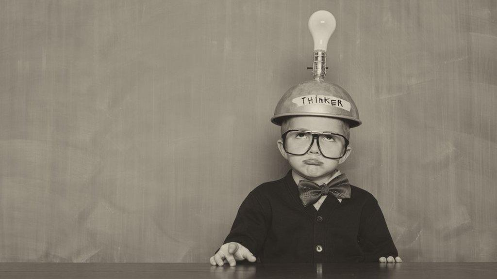 Stock image of a child with a lightbulb above their head