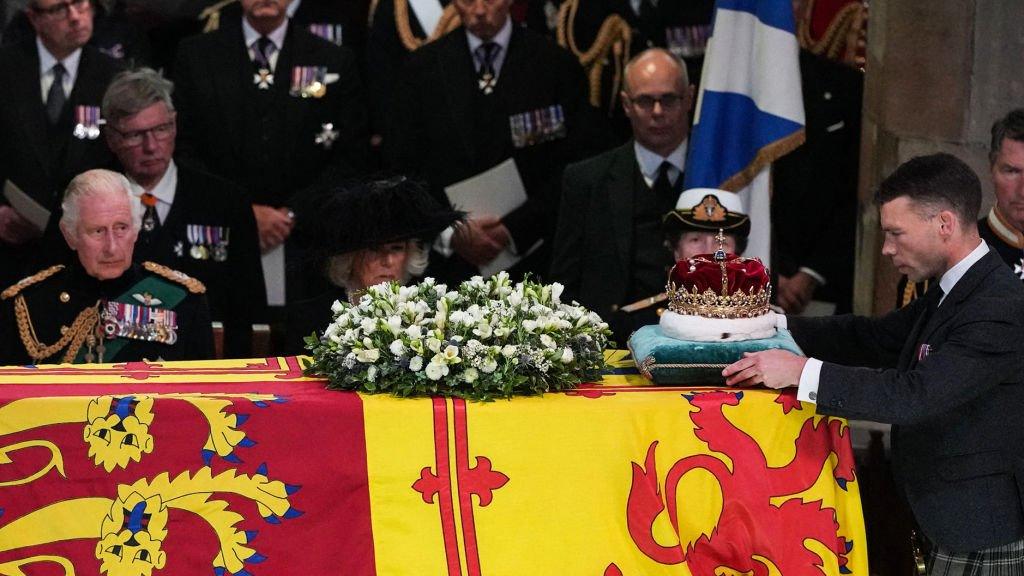 King Charles III (L), Britain's Camilla, Queen Consort (C) and Britain's Princess Anne, Princess Royal watch as Duke of Hamilton, Alexander Douglas-Hamilton places the Crown of Scotland atop the coffin