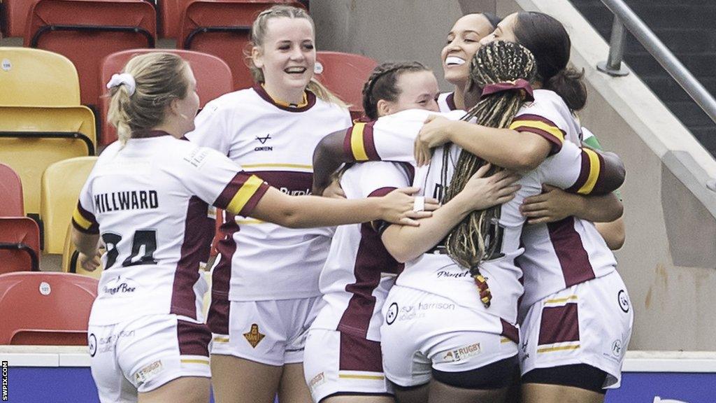 Huddersfield players celebrate an Amelia Brown try at league leaders York