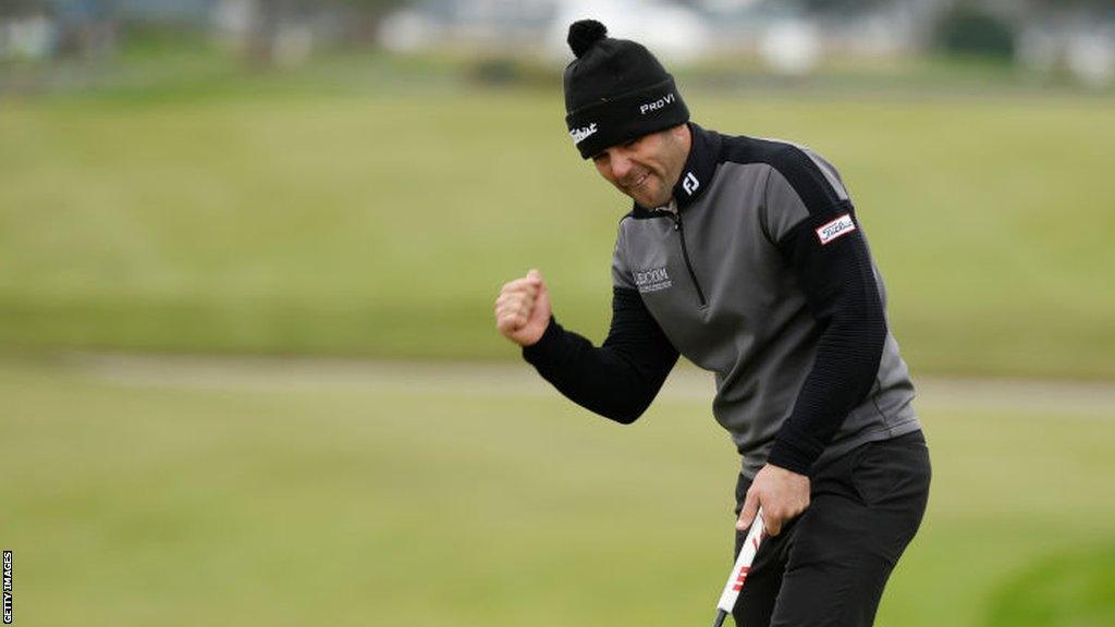 Callum Tarren of England reacts to his birdie putt on the 18th green