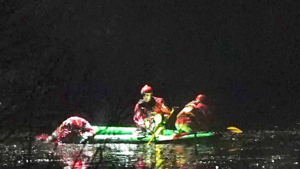 Emergency workers on board a boat on the lake in Babs Mill Park