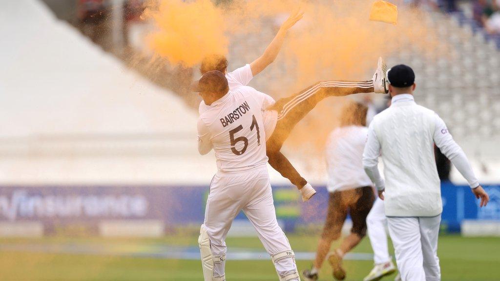 Jonny Bairstow carries a protester