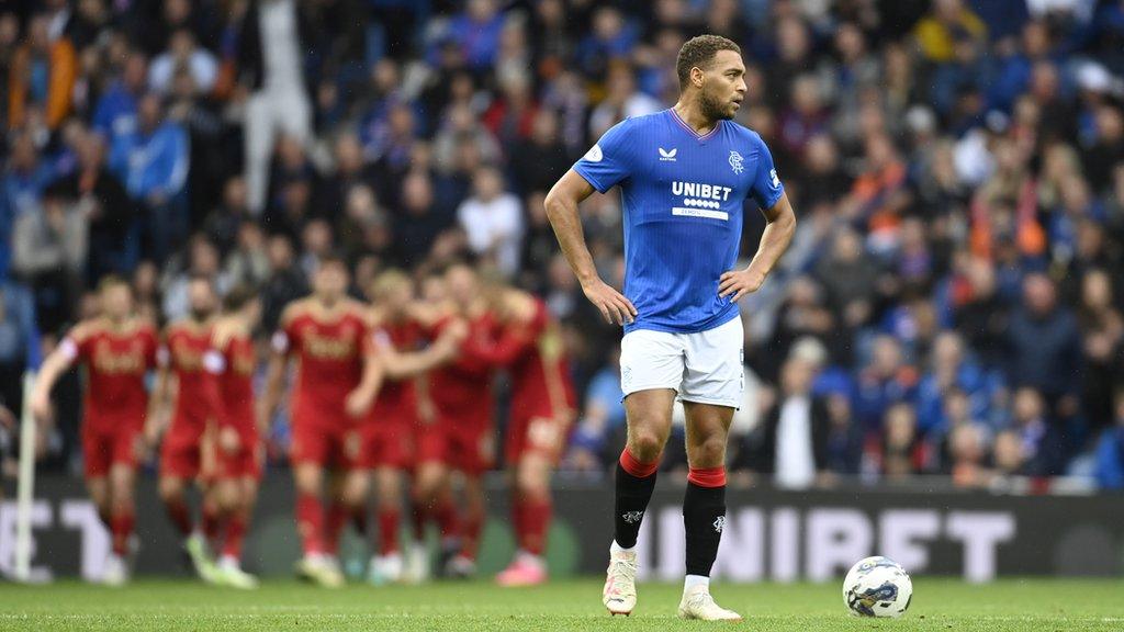 Cyriel Dessers looks dejected as Aberdeen celebrate