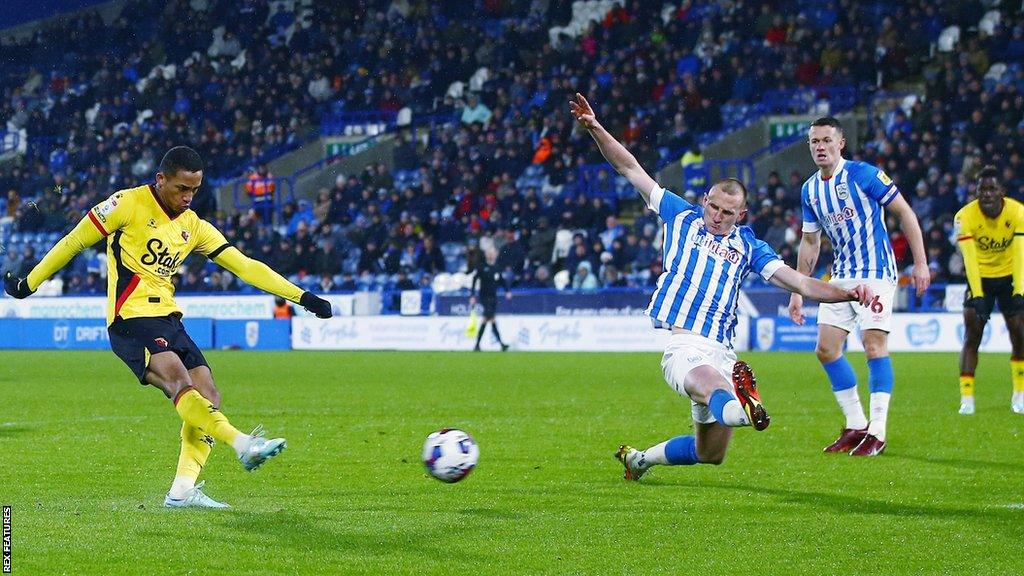 Joao Pedro of Watford scores the opening goal against Huddersfield