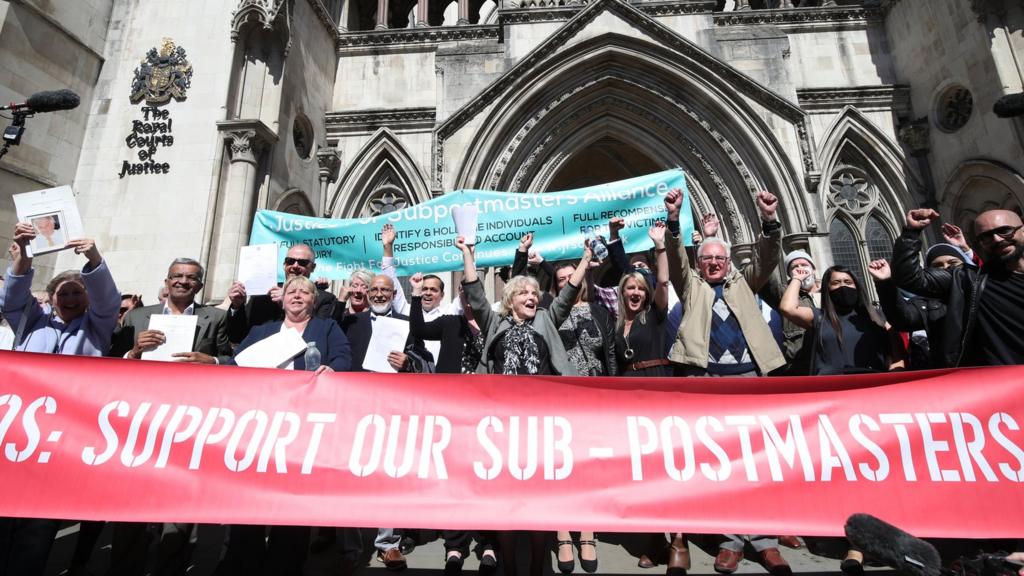 Former post office workers celebrate outside the Royal Courts of Justice, London, after having their convictions overturned by the Court of Appeal.