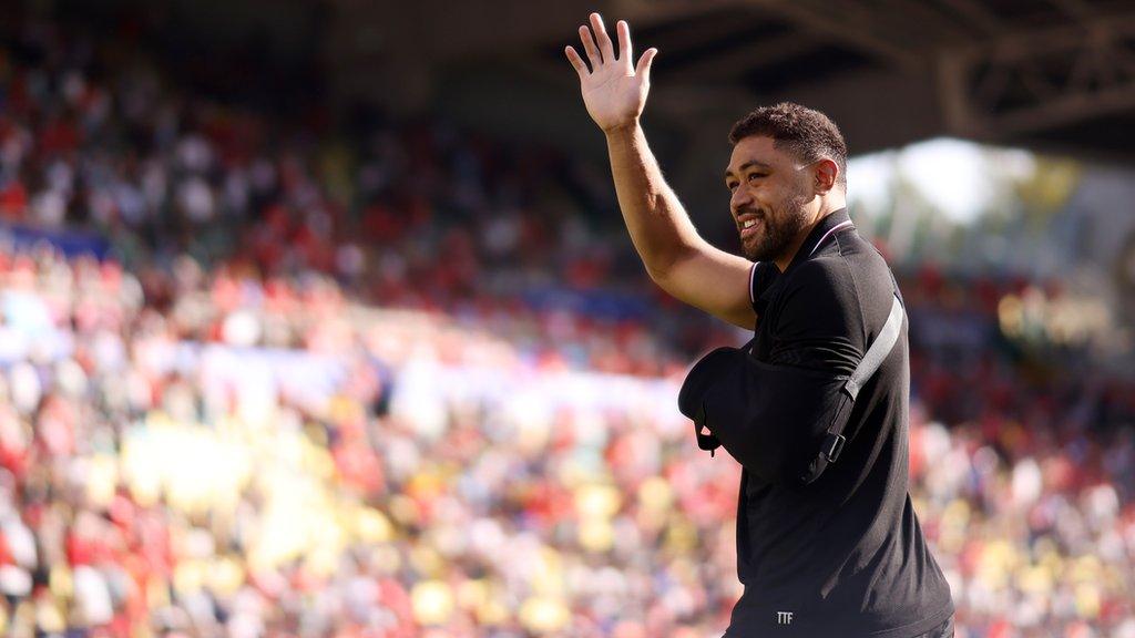 Wales' Taulupe Faletau with his arm in a sling waves to the crowd