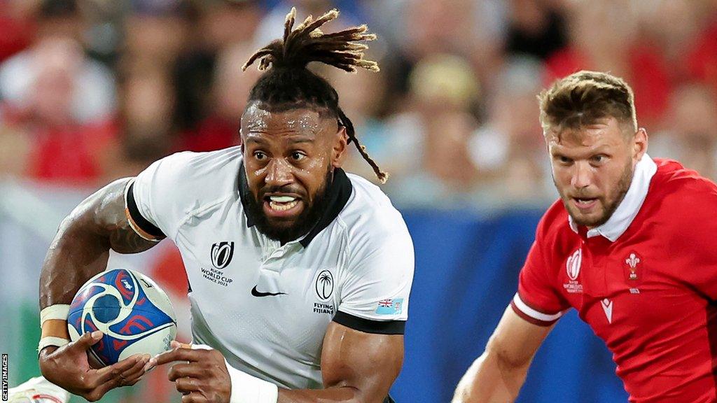 Waisea Nayacalevu of Fiji breaks away with Dan Biggar in pursuit