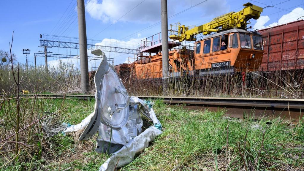 Shards of twisted metal from a Russian rocket are seen in undergrowth near a train line on 25 April 2022 near Lviv, Ukraine