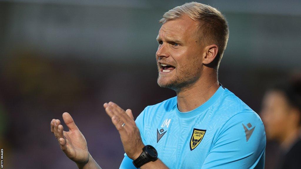 Oxford boss Liam Manning encourages his players during a League One match.