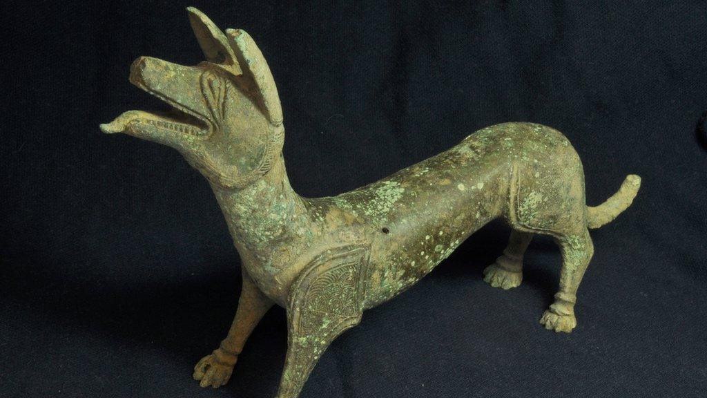 Bronze sculpture of a "licking dog"