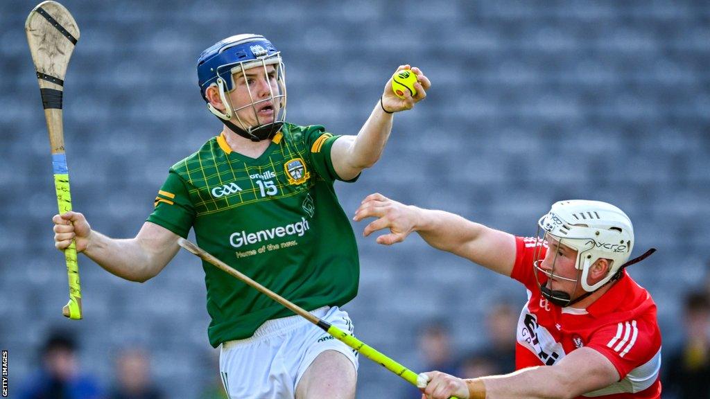 Nicky Potterton is about to score Meath's goal at Croke Park despite Richie Mullan's best efforts