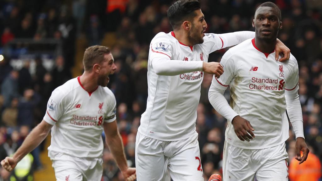 Christian Benteke celebrates his winner for Liverpool with Emre Can