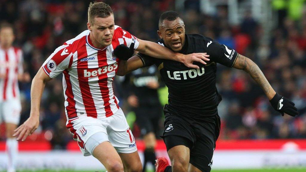 Ryan Shawcross of Stoke challenges Swansea's Jordan Ayew.