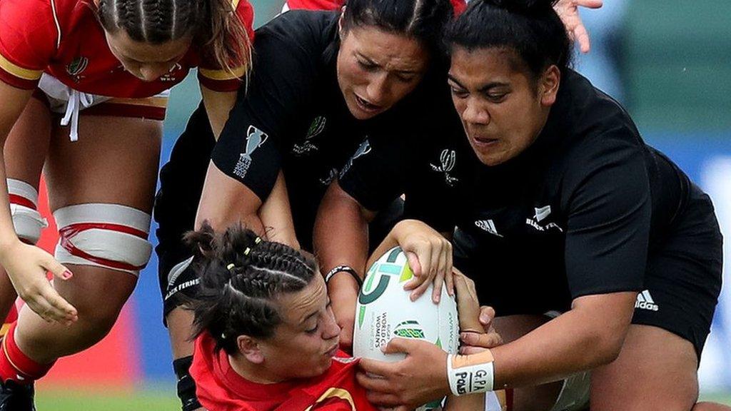 Wales' Sioned Harries is tackled by New Zealand's Sarah Goss and Victoria Subritzky-Nafatali