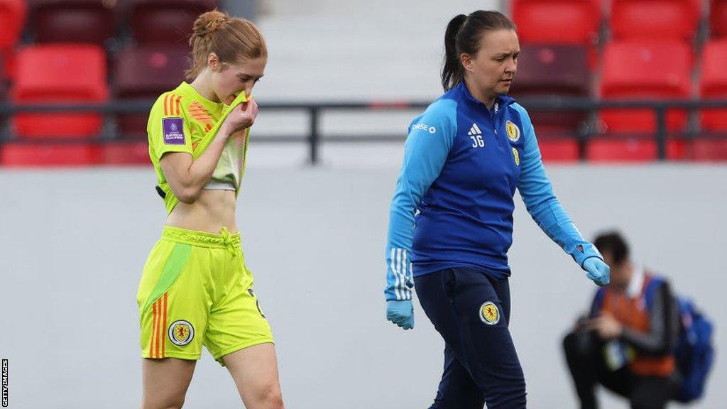 Sandy MacIver leaves the field after suffering an ACL tear