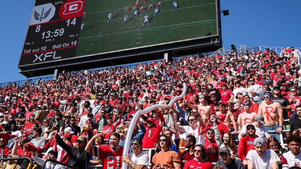 DC Defenders fans holding a 'beer snake' during an XFL game in 2023