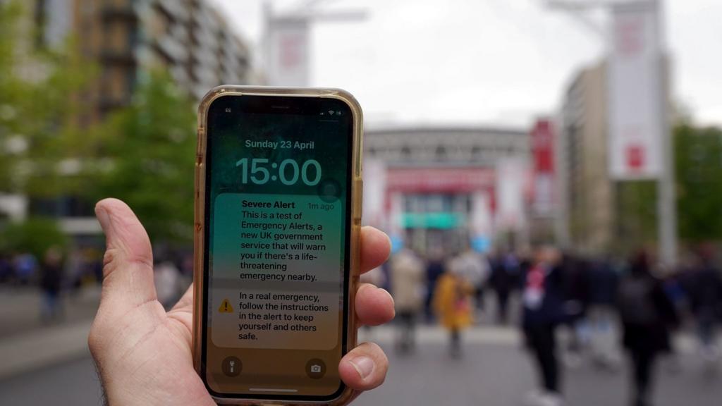 An emergency text alert test on a phone screen ahead of the Emirates FA Cup semi-final match at Wembley Stadium