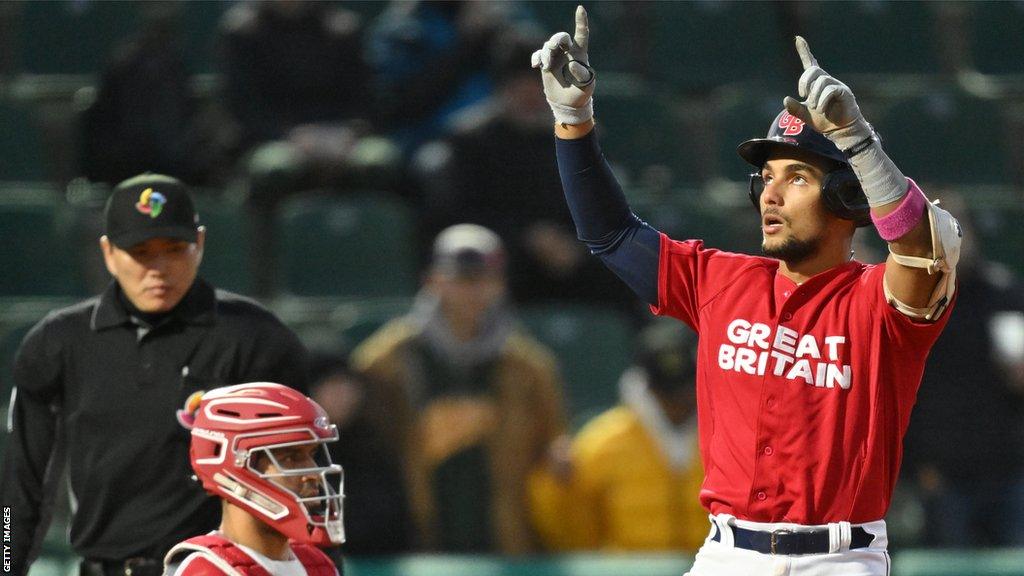 Great Britain catcher Harry Ford (right) celebrates hitting a home run