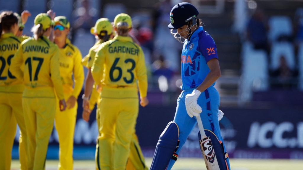 India's Yastika Bhatia (R) walks back to the pavilion after her dismissal during the semi-final T20 women's World Cup cricket match between Australia and India at Newlands Stadium in Cape Town