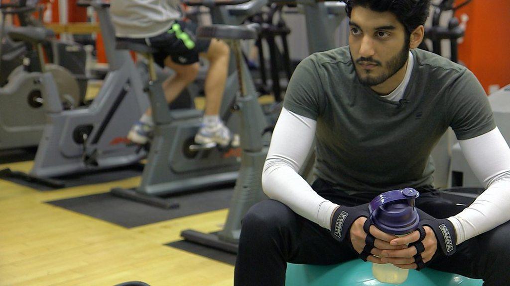 A man sitting in a gym