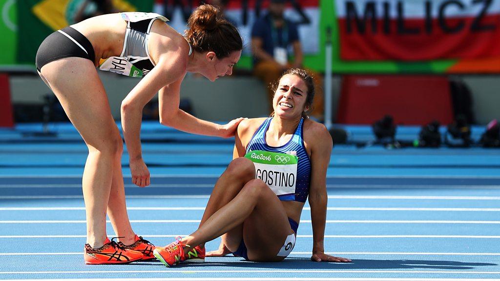 Nikki Hamblin (NZ) helping up Abbey D'Agostino (US) after joint crash on the track