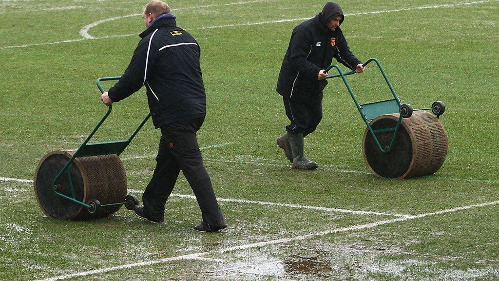 Rodney Parade ground staff work on the pitch